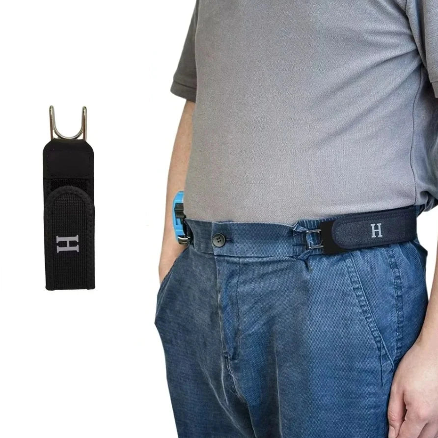 A dark belt with a metal hook and elastic waistband worn around the waist of a person wearing a gray shirt and blue jeans.
