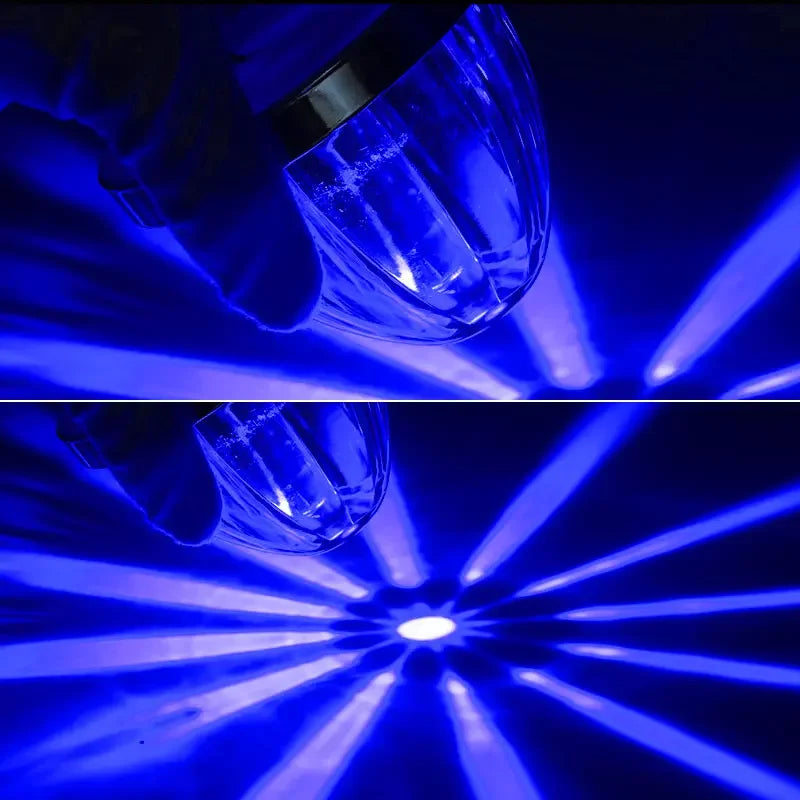 A hand holds a clear LED side marker light, illuminating bright blue beams against a dark background.