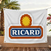 A white flag featuring a logo with an orange sun design and the word RICARD in blue text on an orange background.