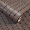 Roll of self-adhesive 3D wood grain wall panels showing a dark brown textured surface.