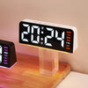 A white digital alarm clock displaying 20:24 on a wooden surface.