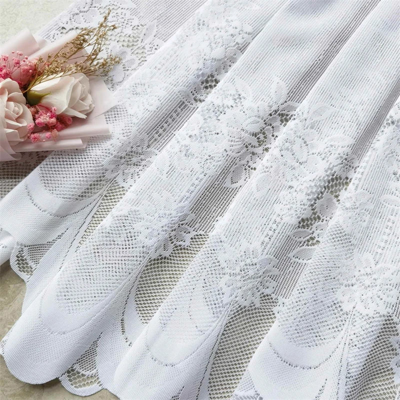 White lace mesh sheer curtain with rod pocket displayed on a light surface.
