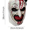 A full head mask of a horror clown with white and red paint splatters on a white face.