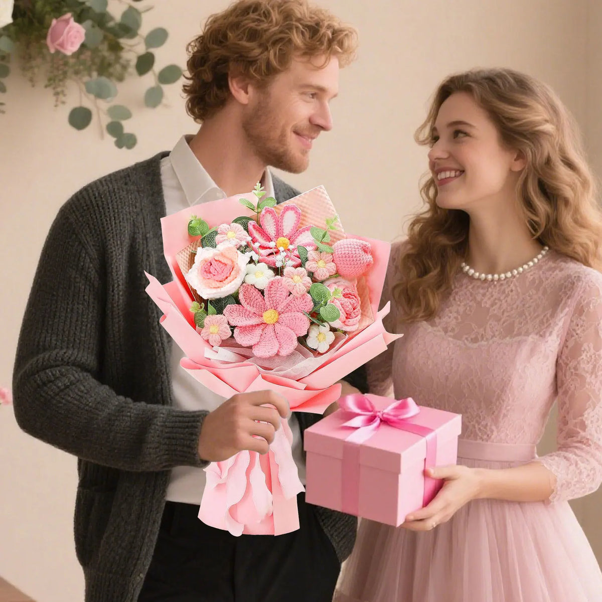 A young couple smiling while a man holds a pink bouquet of handcrafted crochet tulip flowers for a woman.