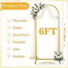 Gold metal arch backdrop stand with sheer white draping and floral arrangements for events