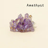 A cluster of purple amethyst crystals with gold inclusions.