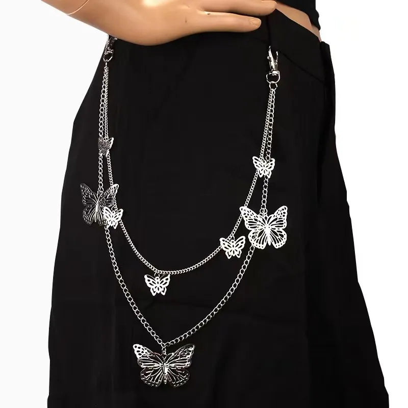 Silver layered butterfly charm necklace worn over a black garment.