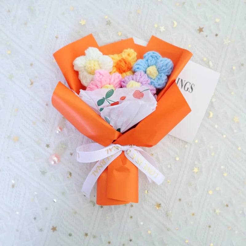 Handmade crochet sunflower mini bouquet wrapped in orange paper with a white ribbon
