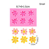 A pink silicone mold with multiple flower shapes for cake decorating, shown alongside finished yellow flowers.