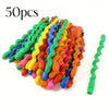 A pile of 50 colorful spiral latex party balloons in various shades of green, yellow, orange, and blue.