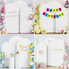White arch covers decorated with balloons and banners for birthday celebrations