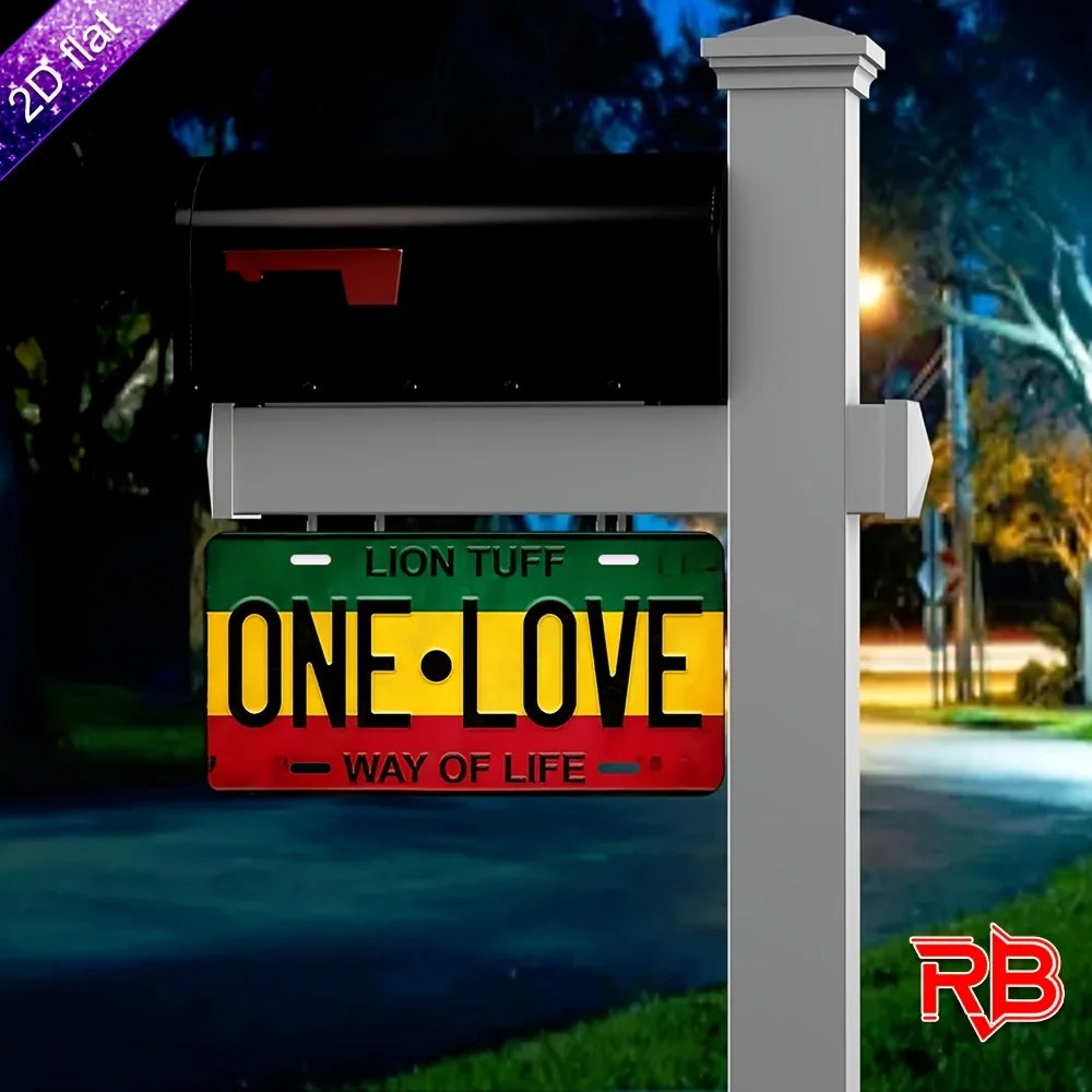 A black metal wall sign with a green and yellow plaque displaying the text ONE LOVE WAY OF LIFE mounted on a white post.