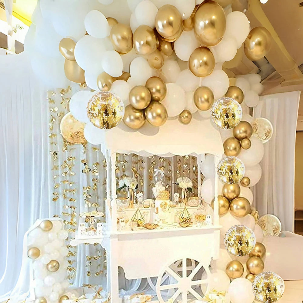 A decorative display featuring white and gold confetti balloons arranged in a tiered structure.