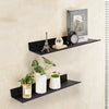 Black floating metal wall shelves displaying a Eiffel Tower, a clock, and potted plants.