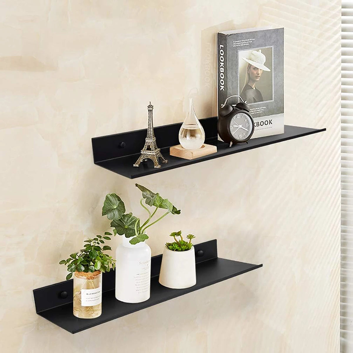 Black floating metal wall shelves displaying a Eiffel Tower, a clock, and potted plants.