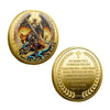 A round gold-plated collectible coin featuring a depiction of Archangel Michael with wings and a sword.