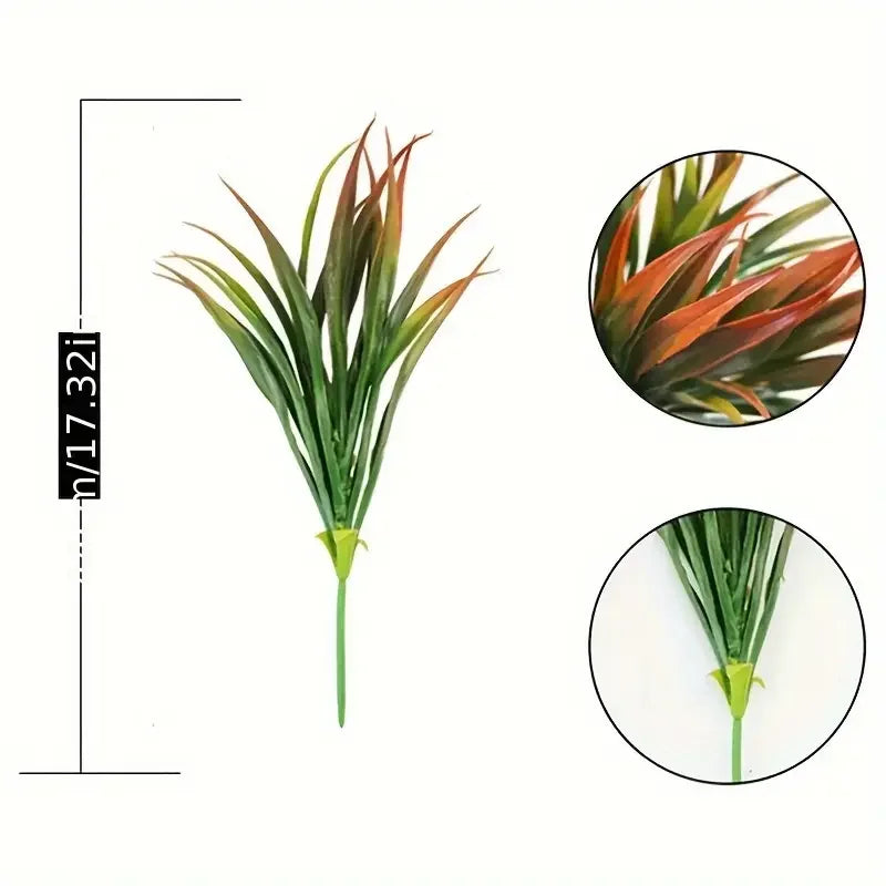 A tall, vibrant green artificial grass plant with reddish-brown tips and tropical flowers.