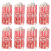 A set of red and white striped popcorn buckets filled with fluffy white popcorn.