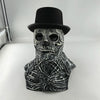 A realistic latex skull mask with a black top hat and skeletal features.