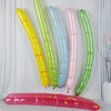 A collection of colorful, elongated balloon strips in yellow, green, blue, and pink are displayed against a white background.
