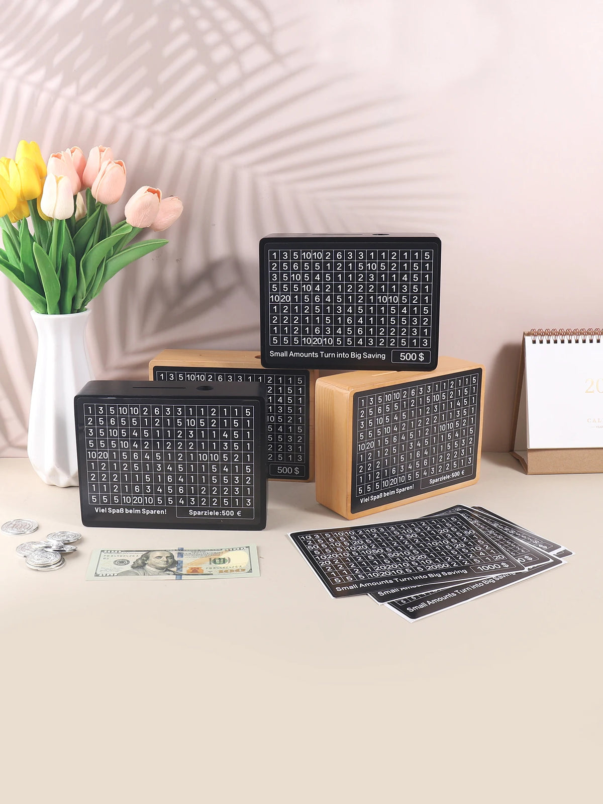 A set of wooden piggy bank savings boxes with numbered slots and a coin is displayed on a light surface.