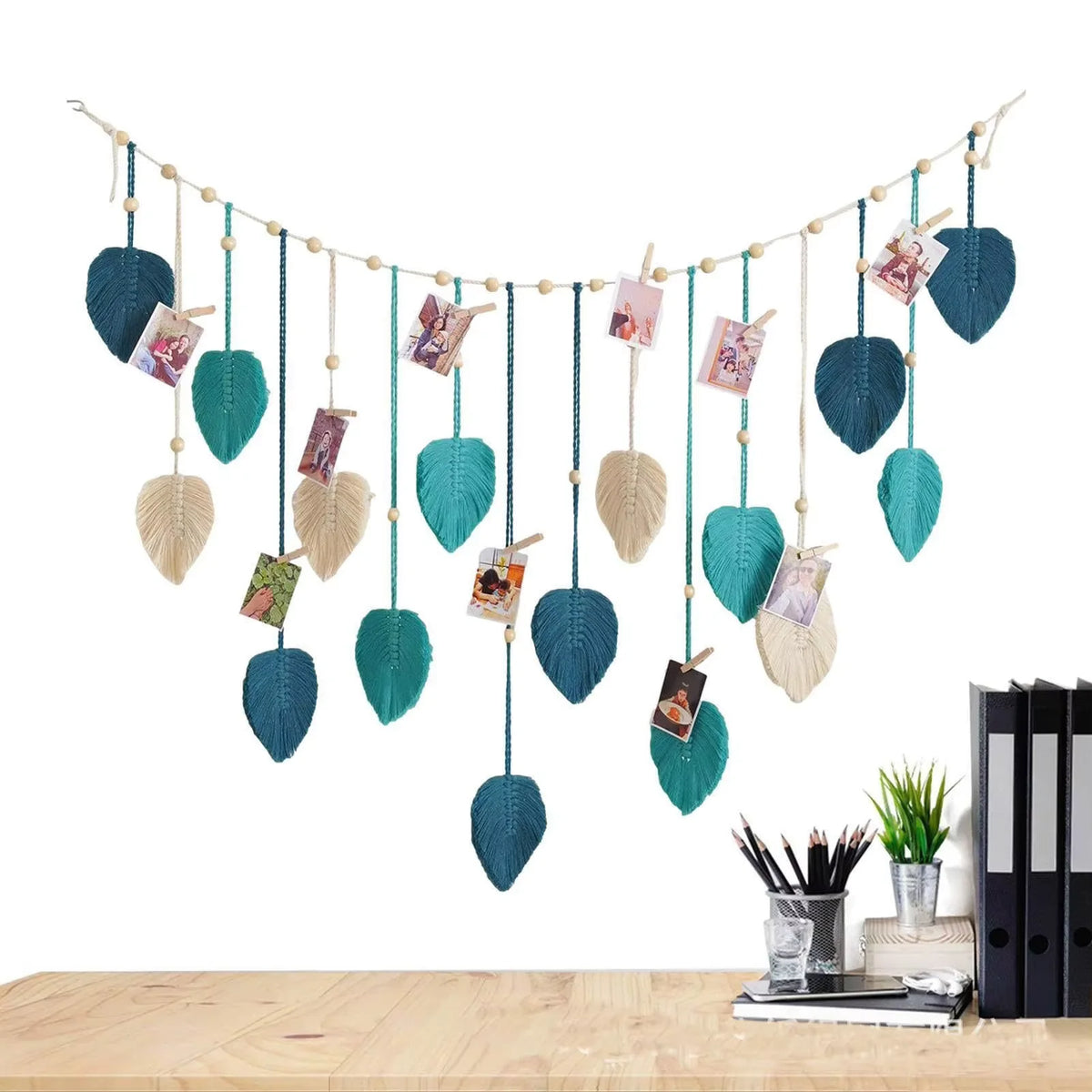 Bohemian macrame leaf wall hanging featuring various sized leaves and floral tassels suspended by twine.