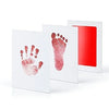 A set of white frames displaying pink handprint and footprint imprints on the paper, with one frame showing a red background.