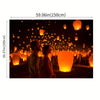A couple stands in a dark setting surrounded by numerous glowing orange lanterns.