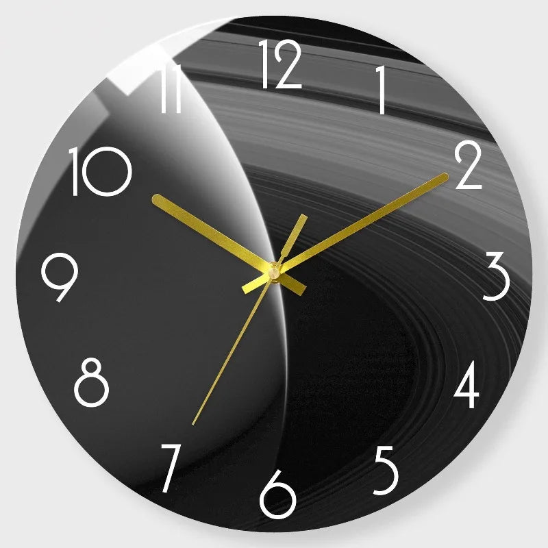 A black round wall clock with gold hands showing a time close to 10 o'clock.