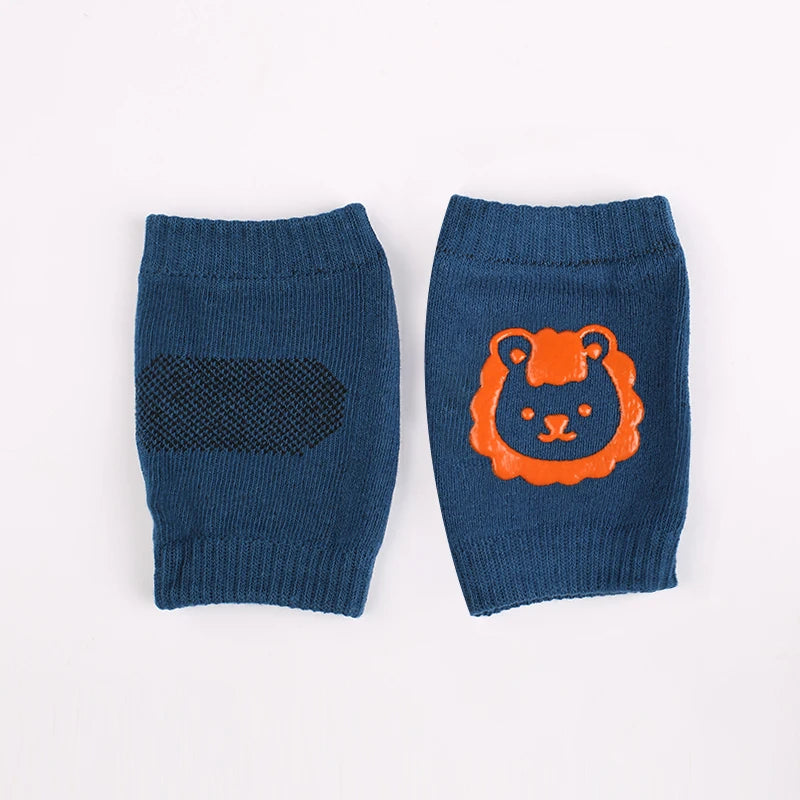 A pair of navy blue knitted knee pads featuring an orange bear face design.