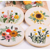 Punch needle embroidery kit featuring floral designs on stamped cloth and tools