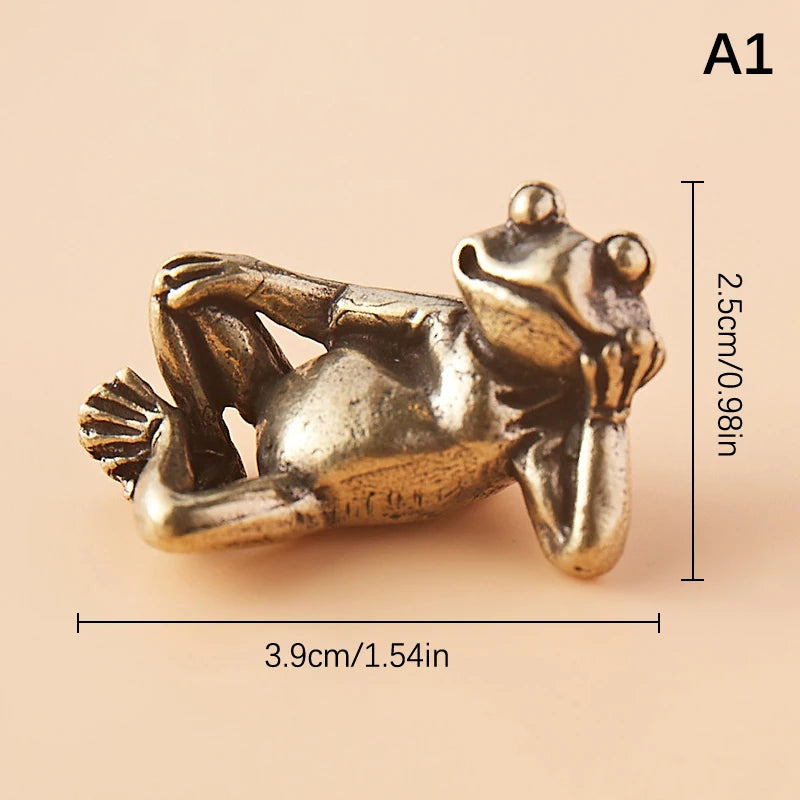 A vintage brass frog statue desktop ornament shown in profile with dimensions 3.9cm long and 2.5cm high.