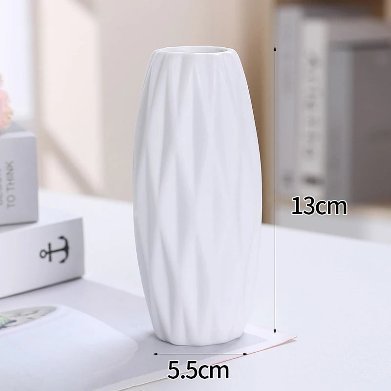 A tall, white ceramic bud vase is shown standing on a white surface with dimension markings.