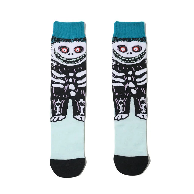 A pair of novelty crew socks featuring black and white skull, alien, and tiger prints on a teal background.