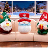 A set of three festive resin Christmas dwarf figurines, including a green and white gnome, a red and white snowman, and a gre