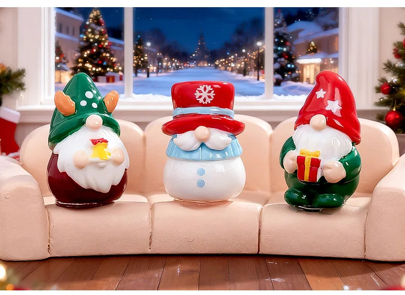 A set of three festive resin Christmas dwarf figurines, including a green and white gnome, a red and white snowman, and a gre