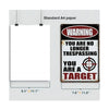 A vintage metal tin sign with a warning label on a white paper background.
