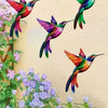 Set of four metal hummingbird wall decor featuring vibrant iridescent colors against a light background.