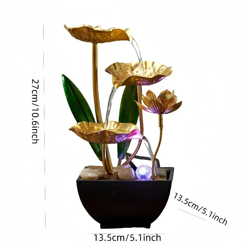 Gold lotus leaves and stems forming a water fountain with blue LED lighting in a black pot