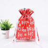A red festive drawstring gift bag with white snowflake designs is shown against a white background.