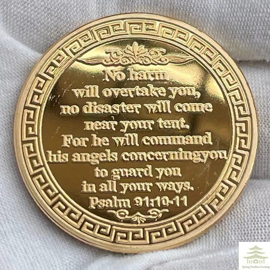 A round gold coin featuring Psalm 91:10-11 engraved on its surface.