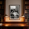 Framed black and white photograph of a man making a peace sign hanging in a wooden bookcase