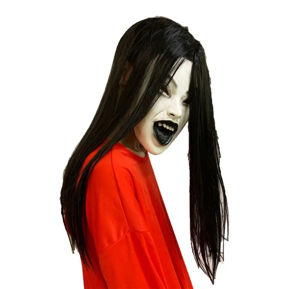A realistic latex horror mask with long black hair, featuring a pale face and dark features.