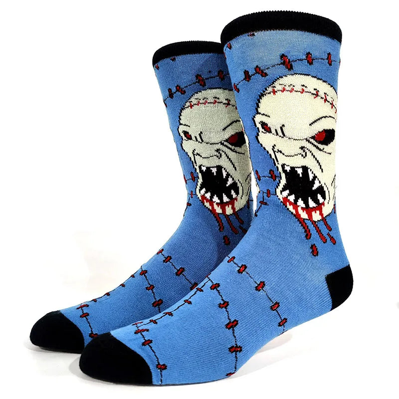 A pair of blue crew socks featuring a skull and alien print with red stitching details.