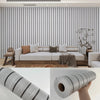 Roll of faux wood grain self-adhesive wallpaper showing a textured gray pattern.