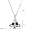 Silver pendant necklace featuring a diamond-inlaid Saturn design with a cross charm.