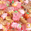 A close-up of colorful, translucent resin figures shaped like capybaras and other animals with soft glow effects.
