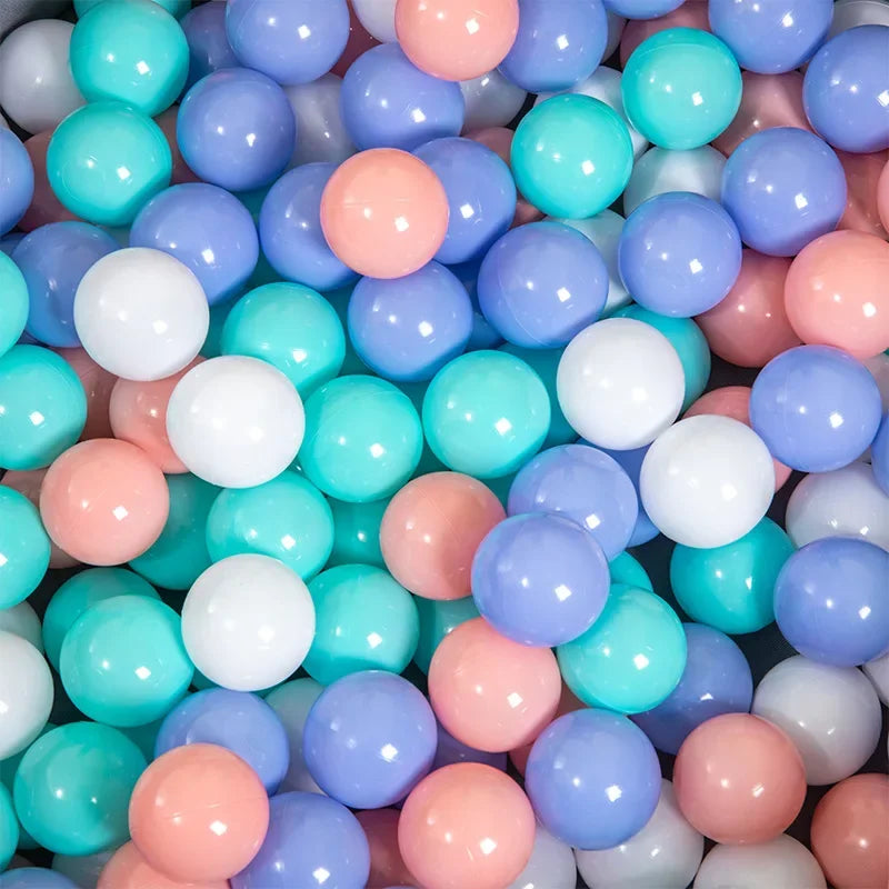 A close-up view of a 50-pack of colorful, glossy, spherical ocean balls in shades of blue, pink, and white.