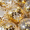 A close-up of round balloons filled with white latex and decorated with gold confetti.