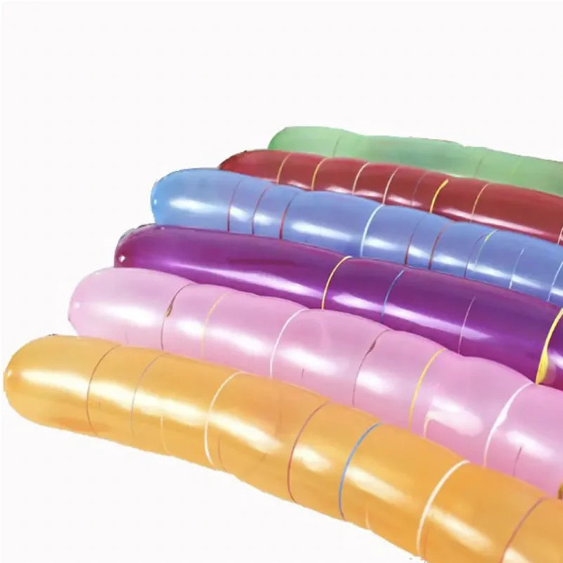 A stack of colorful latex rocket balloons in shades of green, red, blue, purple, pink, and orange.